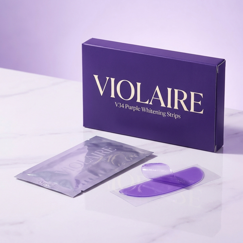 Violaire V34 Purple Whitening Strips — premium violet box with foil sachet and purple strip on marble